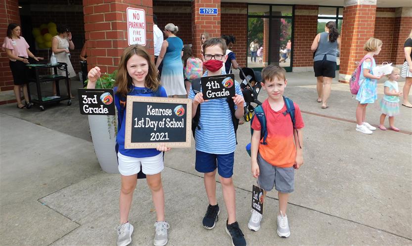 A groups of students in front of a middle school